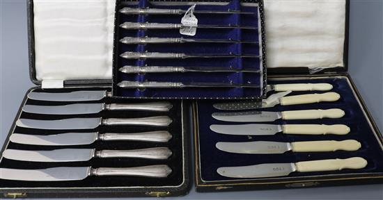 Three cases set of six cake knives, two with silver handles, one with silver blades.